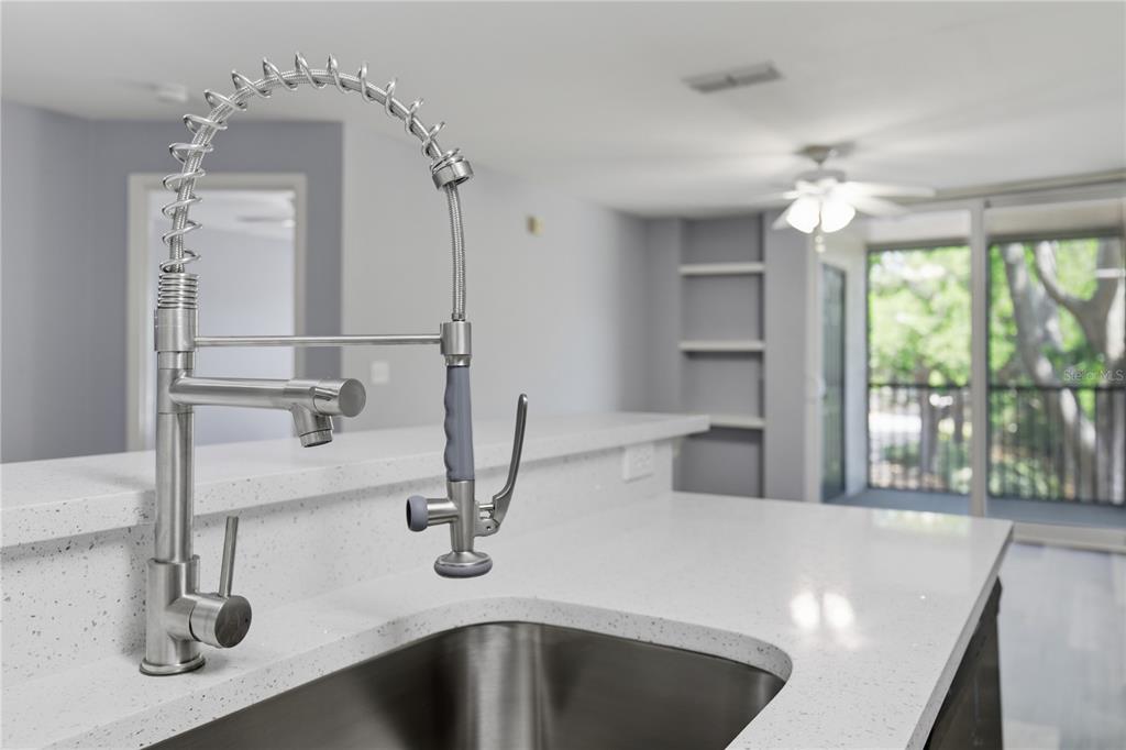 A bathroom features a white vanity, a round mirror, a toilet, and a shower-tub combo — 7605 PISSARRO DRIVE UNIT 13204, ORLANDO, FL