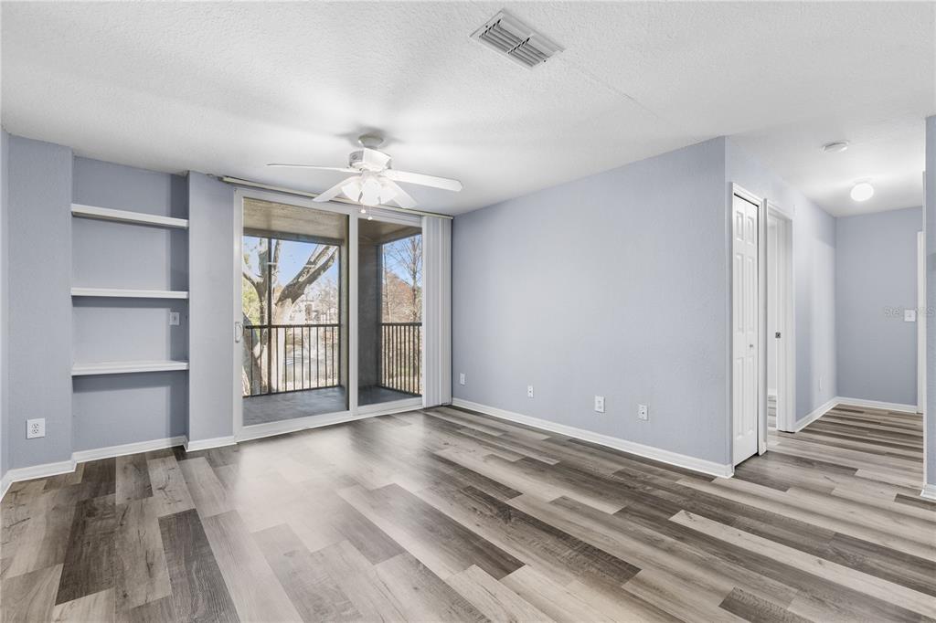 A kitchen sink with a gooseneck faucet sits in a white countertop with white cabinets — 7605 PISSARRO DRIVE UNIT 13204, ORLANDO, FL
