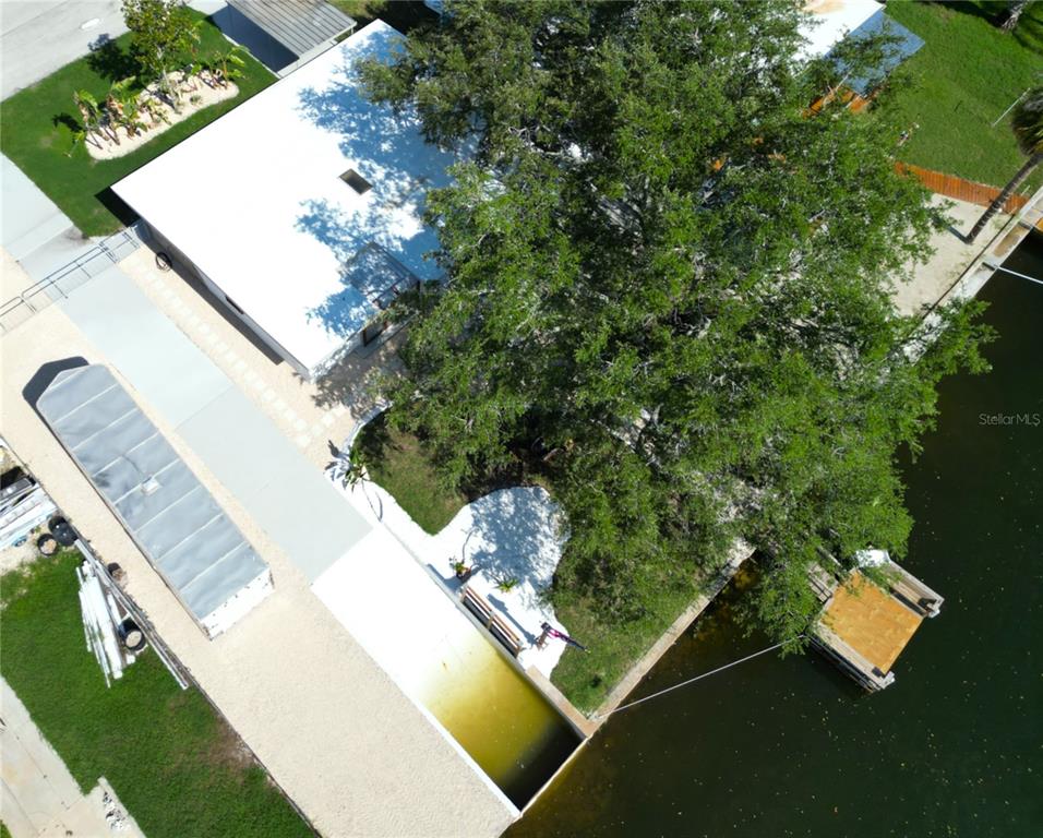 An aerial view shows a residential neighborhood with houses situated along a network of canals — 13400 CAROL DRIVE, HUDSON, FL