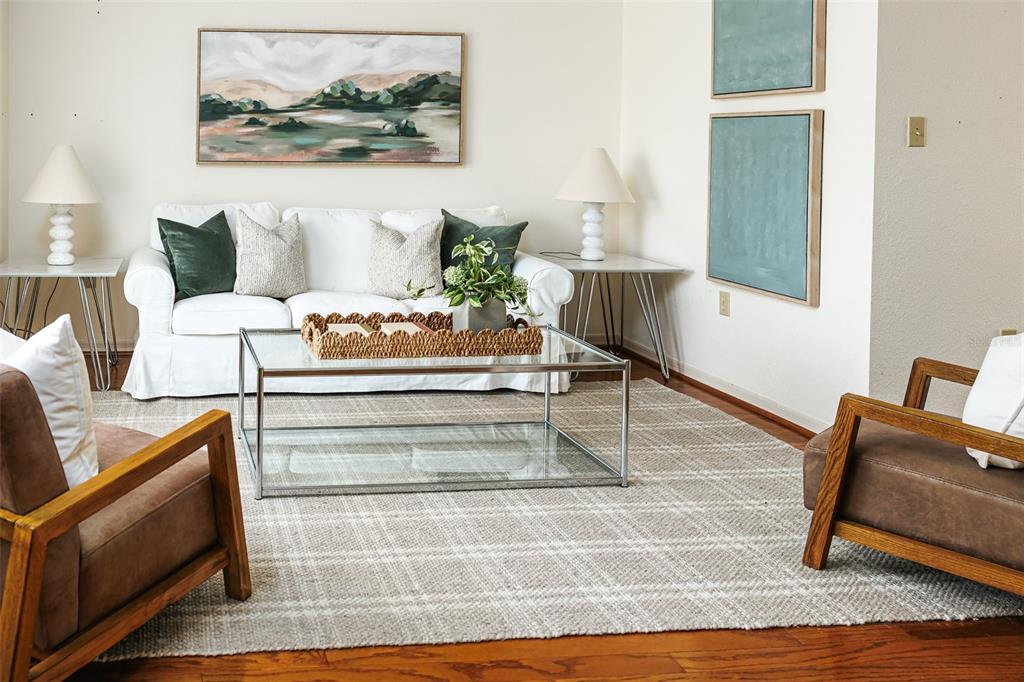 A living room features a white sofa, two brown armchairs, and a glass coffee table — 6712 CYPRESS DRIVE, LAKE WALES, FL