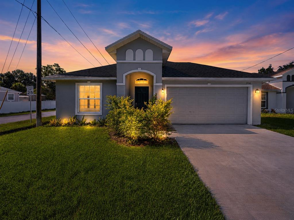 A single-story house with a gray exterior, a two-car garage, and a landscaped front yard — 1534 PINE STREET, ORLANDO, FL