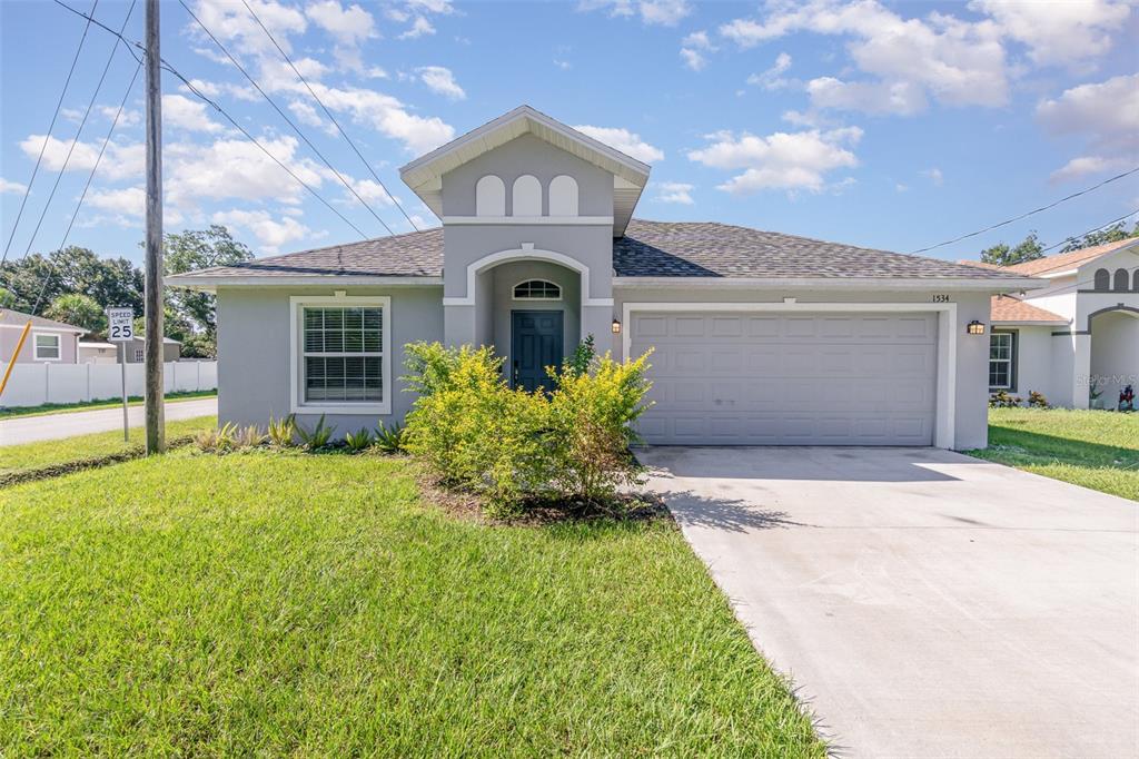 A single-story gray house with a two-car garage, a front lawn, and a concrete driveway — 1534 PINE STREET, ORLANDO, FL