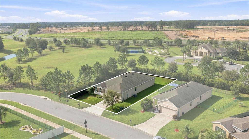 An aerial view shows a single-story house with a white outline on a suburban lot — 6457 SW 89TH LOOP, OCALA, FL