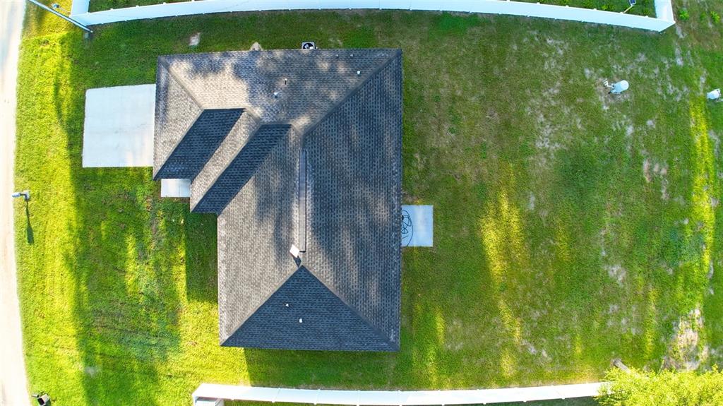 An open-concept living area features light gray walls, wood-look flooring, a kitchen island, and a ceiling fan — 13264 SW 111TH LANE, DUNNELLON, FL
