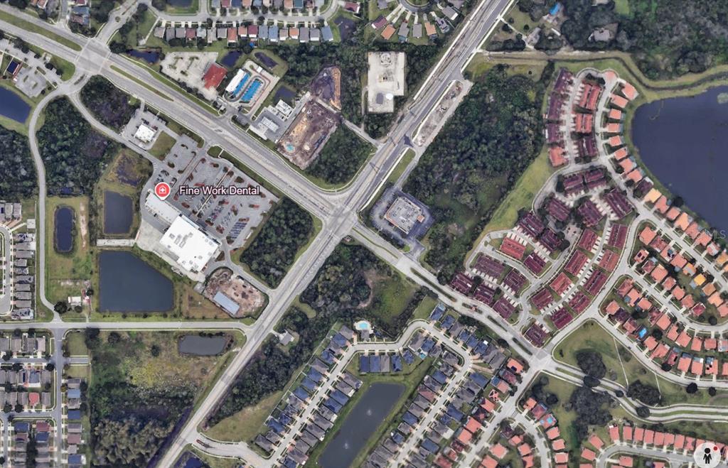 This is an aerial map view of a commercial building and surrounding residential neighborhoods — SIMPSON ROAD, KISSIMMEE, FL