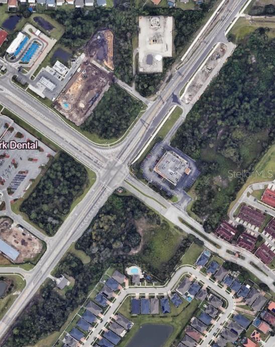 This is an aerial view of a road intersection surrounded by commercial and residential properties — SIMPSON ROAD, KISSIMMEE, FL