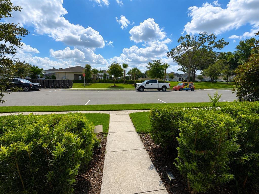 A sidewalk leads toward a street with parked vehicles and a row of mailboxes — 4086 LUSH VIEW DRIVE, APOPKA, FL