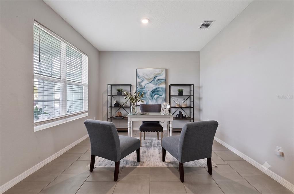 A home office features a desk, two chairs, two bookshelves, and tile flooring — 13017 WILLOW GROVE DRIVE, RIVERVIEW, FL
