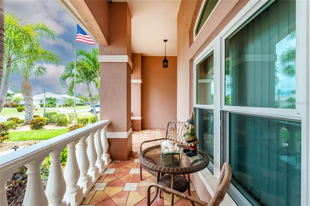 A living room with gray sofas, a central ottoman, and a view of a pool — 310 CORAL CREEK DRIVE, PLACIDA, FL