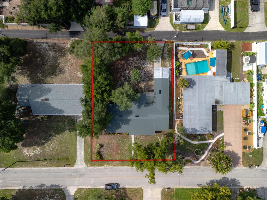 An aerial view shows a house with a dark roof within a red property boundary — 6 GOLFVIEW CIRCLE NE, WINTER HAVEN, FL