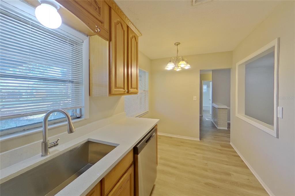 A kitchen with light wood cabinets, a stainless steel sink, and a dishwasher — 2022 68TH AVENUE S, ST PETERSBURG, FL
