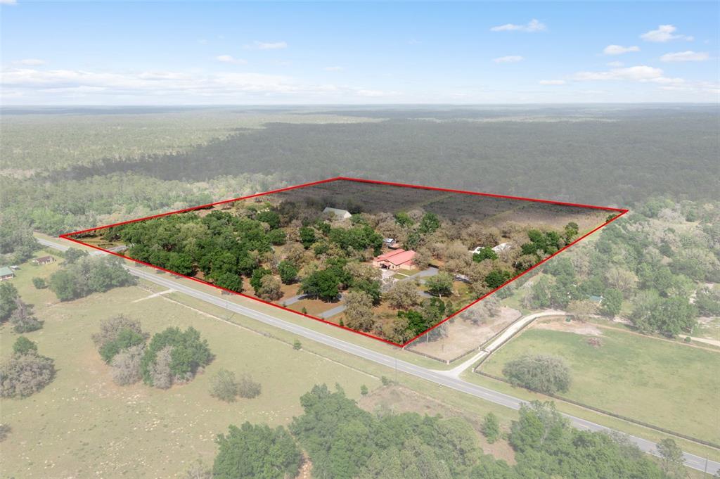 An aerial view shows a rural property with a house and trees outlined in red — 8123 S LECANTO HIGHWAY, LECANTO, FL