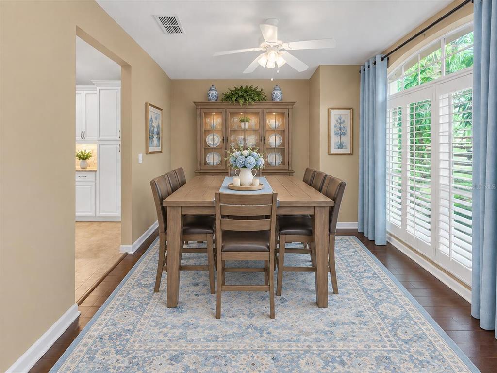 A screened-in patio features a small swimming pool, outdoor furniture, and a paved deck — 624 HARDWOOD CIRCLE, ORLANDO, FL