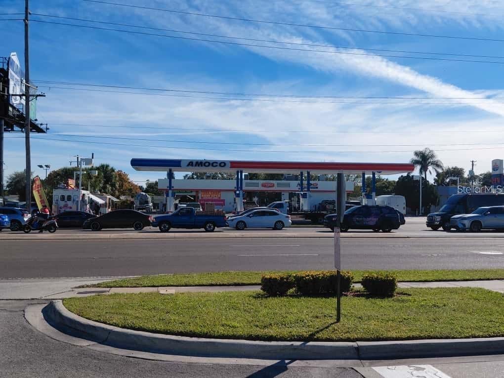 An Amoco gas station with a canopy and several cars parked in front — 7906 W HILLSBOROUGH AVENUE, TAMPA, FL