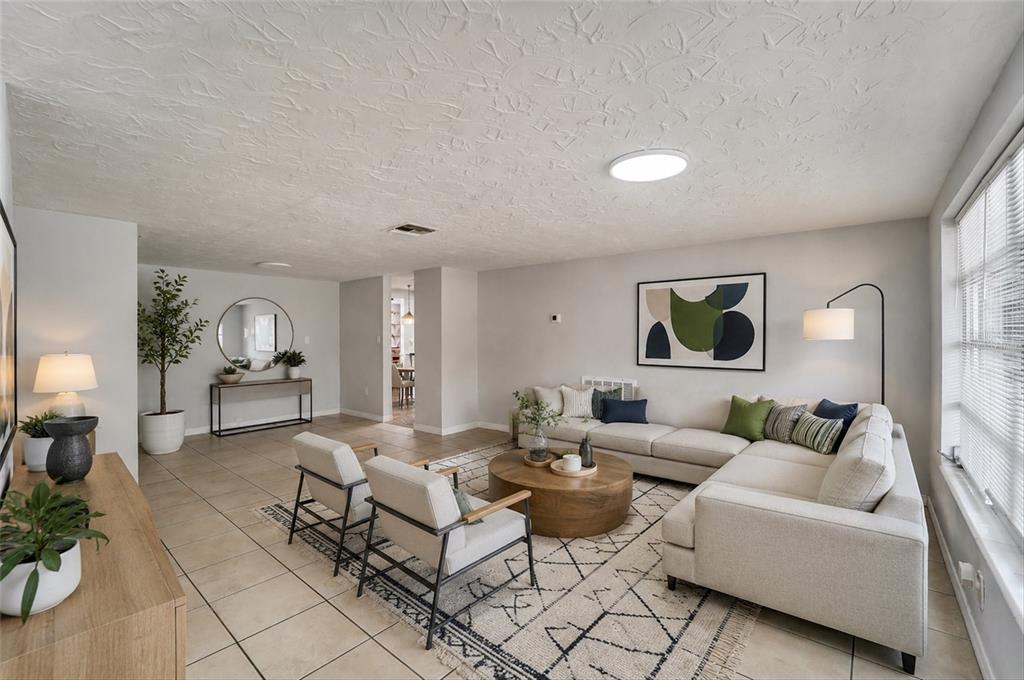 A kitchen features cream cabinets, dark granite countertops, a black dishwasher, and a coffee station — 5344 NANCY LANE, HOLIDAY, FL