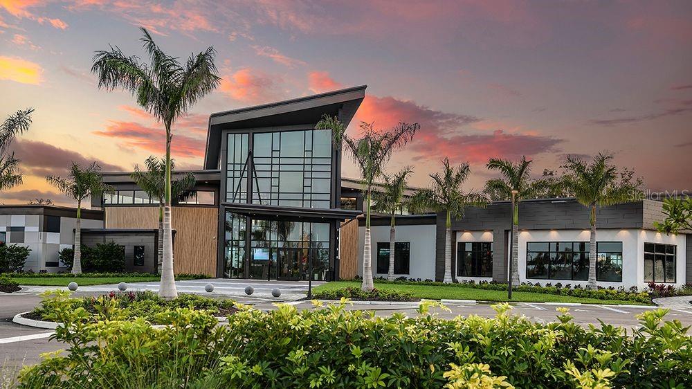 A modern gym features rows of treadmills, weight machines, and overhead geometric lighting fixtures — 10847 ECLIPSE STREET, SARASOTA, FL