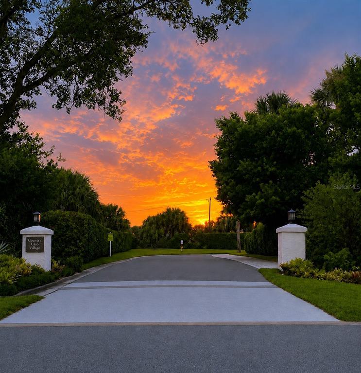 A single-story house with a red tile roof and palm trees in the front yard — 2725 CLUBHOUSE DRIVE, LAKE WALES, FL