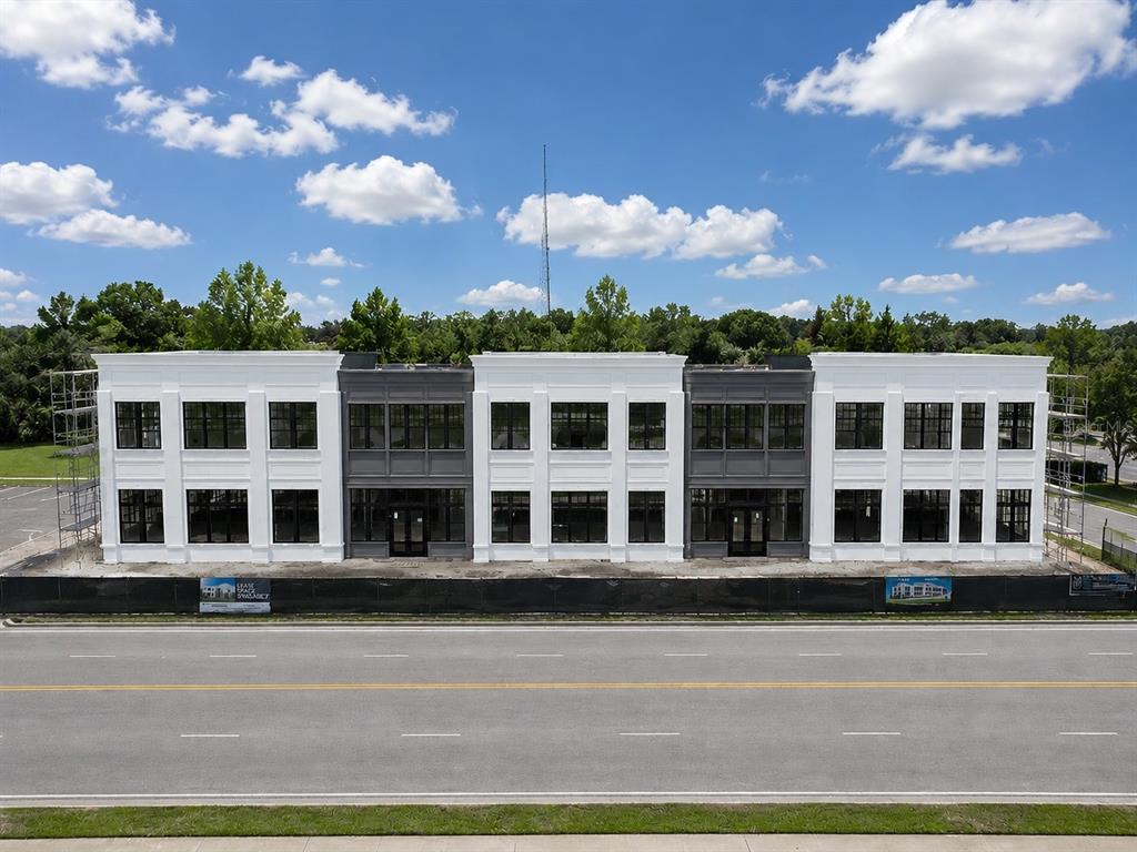 An exterior view of a two-story commercial building under construction with white and gray panels — 950 S DILLARD STREET, WINTER GARDEN, FL