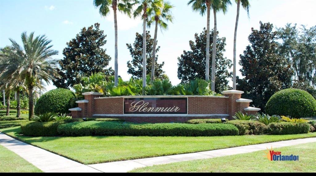 A brick entrance sign for the Glenmuir community features palm trees and manicured landscaping — 10914 LEDGEMENT LANE, WINDERMERE, FL