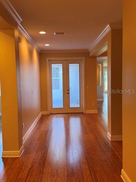 A hallway with hardwood floors leads to a set of glass-paned double doors — 6803 LOCKINGTON COURT, TAMPA, FL
