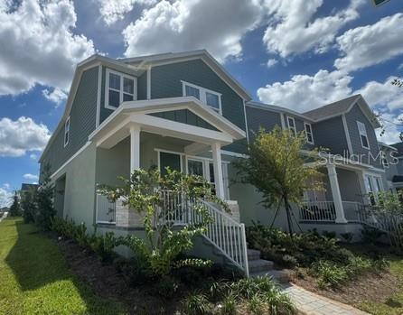 A two-story house with green siding, a covered front porch, and a white railing — 416 OAK FLAT ALLEY, GROVELAND, FL