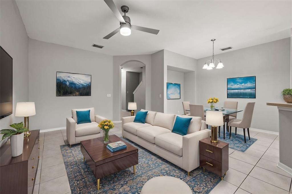 A living and dining area with tile floors, a ceiling fan, and neutral furniture — 10418 TULIP FIELD WAY, RIVERVIEW, FL