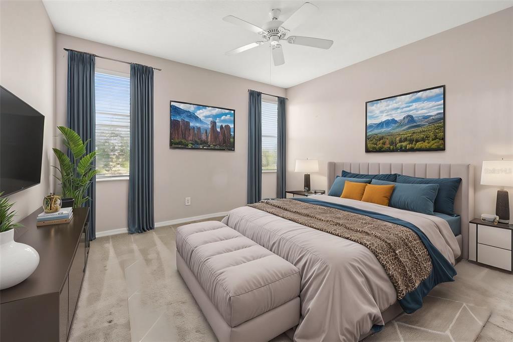 A bedroom features a bed with a tufted bench, two windows with curtains, and wall art — 10418 TULIP FIELD WAY, RIVERVIEW, FL