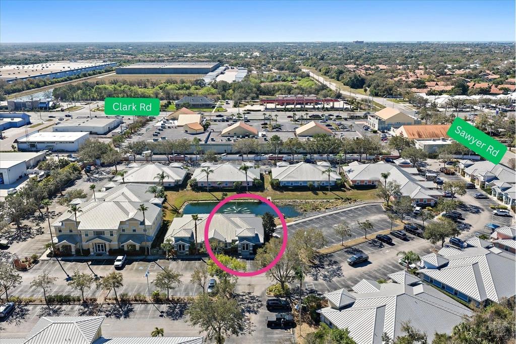 An aerial view shows a commercial office complex with a pond and parking lot — 5605 MARQUESAS CIRCLE UNIT 12C, SARASOTA, FL