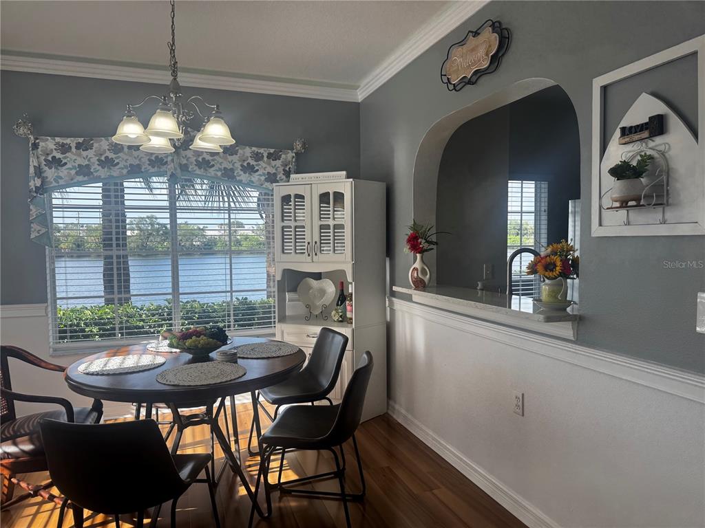 A living room features a blue sofa, a wooden coffee table, and a wall-mounted television — 3603 45TH TERRACE W UNIT 101, BRADENTON, FL