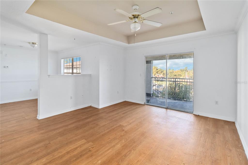 A three-story apartment building with white stucco walls, dark trim, and exterior staircases — 3714 PALM DESERT LANE UNIT 5336, ORLANDO, FL