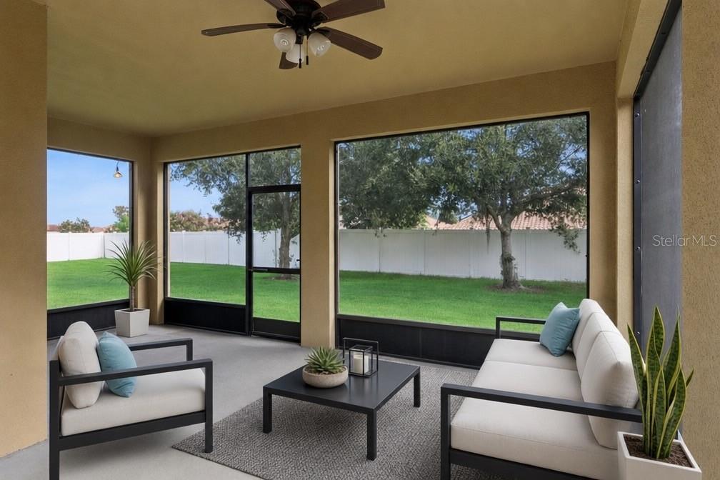 A screened-in patio features modern outdoor furniture, a ceiling fan, and views of a backyard — 1799 ALTAVISTA CIRCLE, LAKELAND, FL