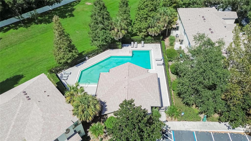 An aerial view shows a swimming pool, a clubhouse, and surrounding landscaping and parking — 2919 ROYAL TUSCAN LANE, VALRICO, FL