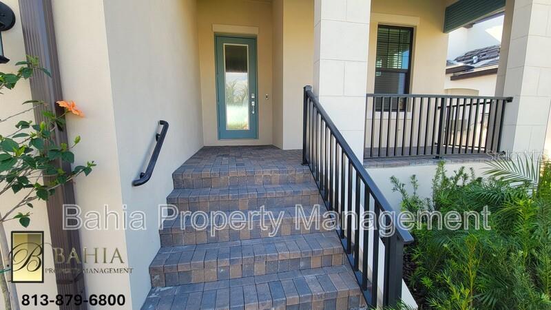A paved staircase with a black metal railing leads to a teal front door — 1074 SEAGRAPE DRIVE, RUSKIN, FL