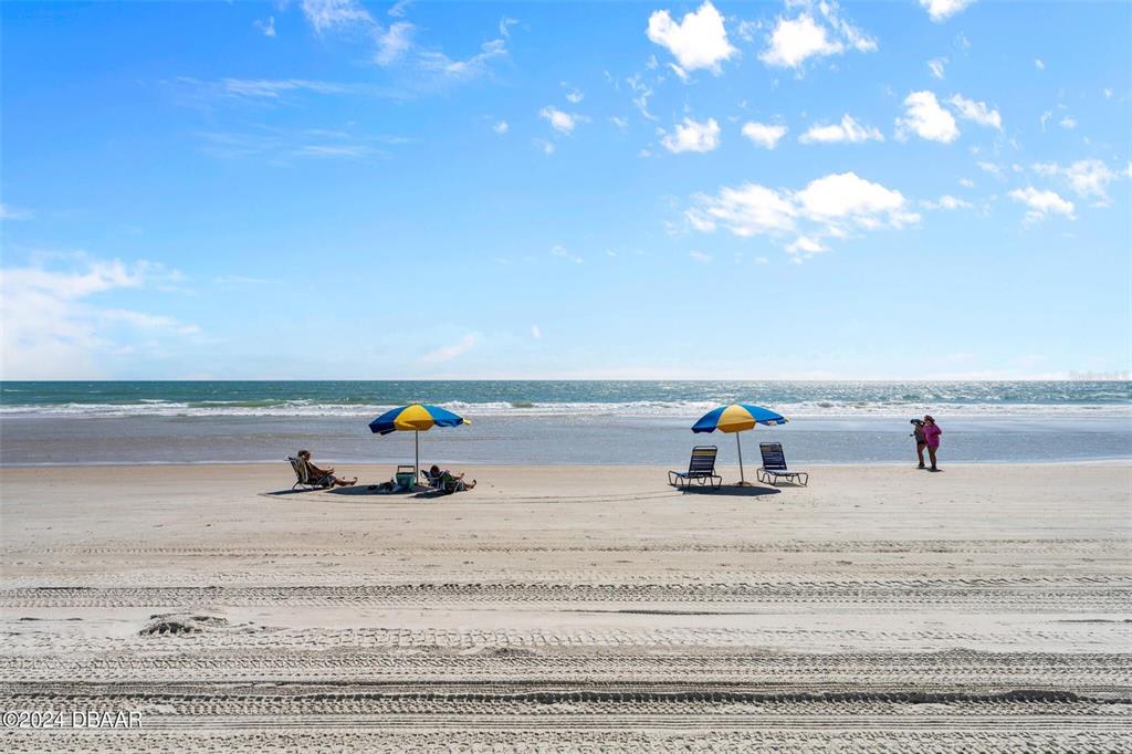 A studio apartment features a kitchenette, a bed, a leather sofa, and an ocean view — 2301 S ATLANTIC AVENUE UNIT 236, DAYTONA BEACH, FL