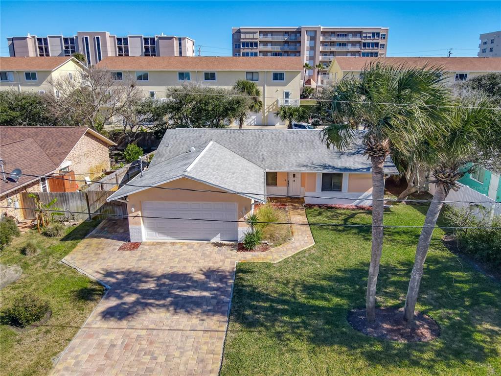 An aerial view shows a single-story house with a paved driveway and two palm trees — 4761 RIVERGLEN BOULEVARD, PONCE INLET, FL