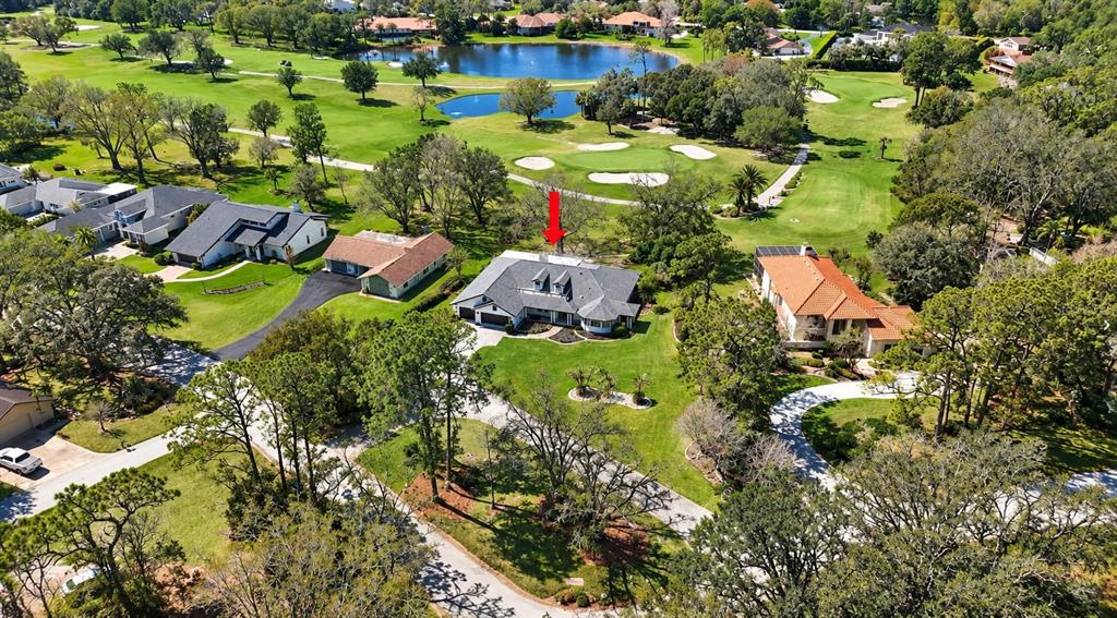 An aerial view shows a house with a dark roof situated on a golf course — 5331 SADDLEBROOK WAY, WESLEY CHAPEL, FL