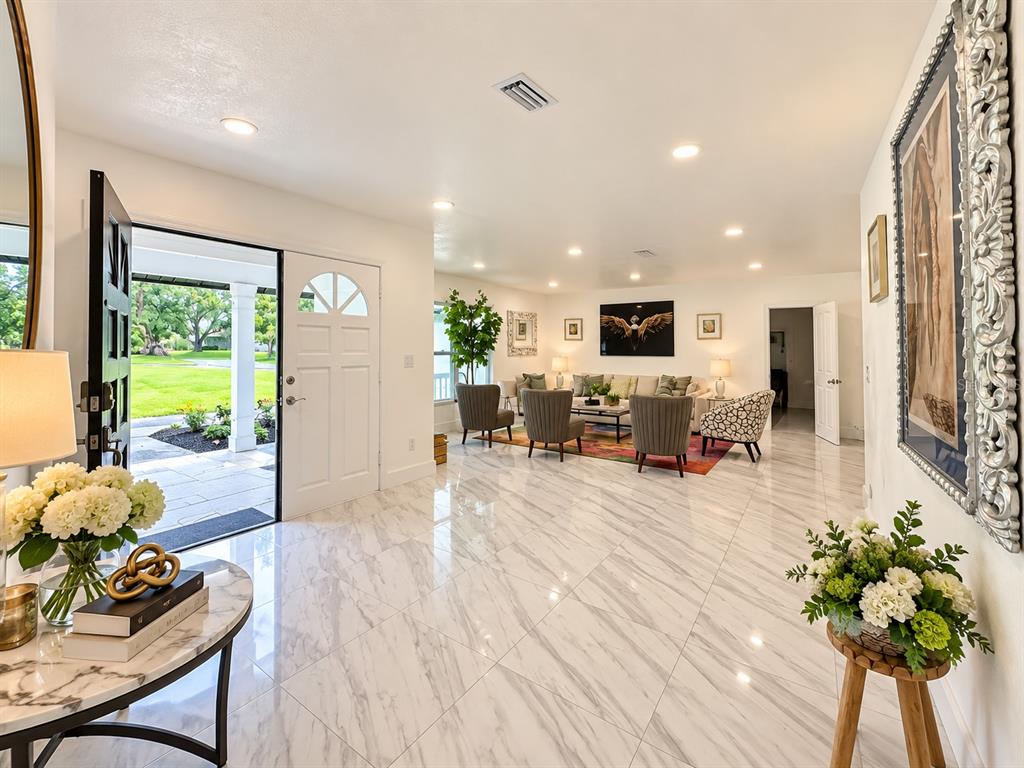 An aerial view shows a single-story house with a gray shingled roof and dormer windows — 5331 SADDLEBROOK WAY, WESLEY CHAPEL, FL