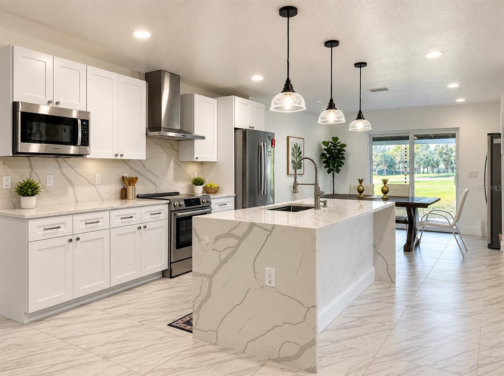 A pair of dark double doors with arched glass panels set in a white entryway — 5331 SADDLEBROOK WAY, WESLEY CHAPEL, FL