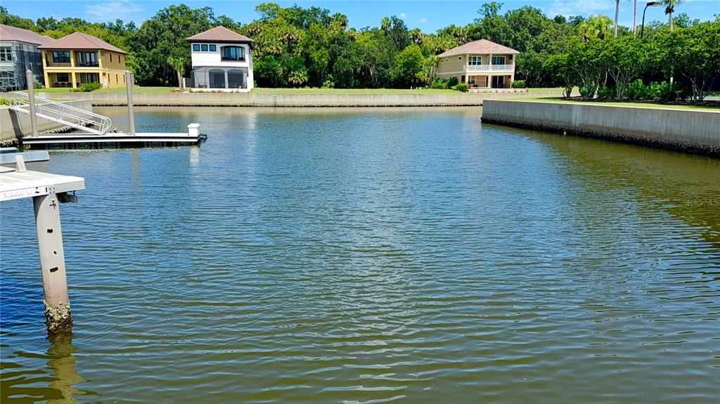 A canal view features a boat dock in the foreground and houses in the background — 243 YACHT HARBOR DRIVE, PALM COAST, FL