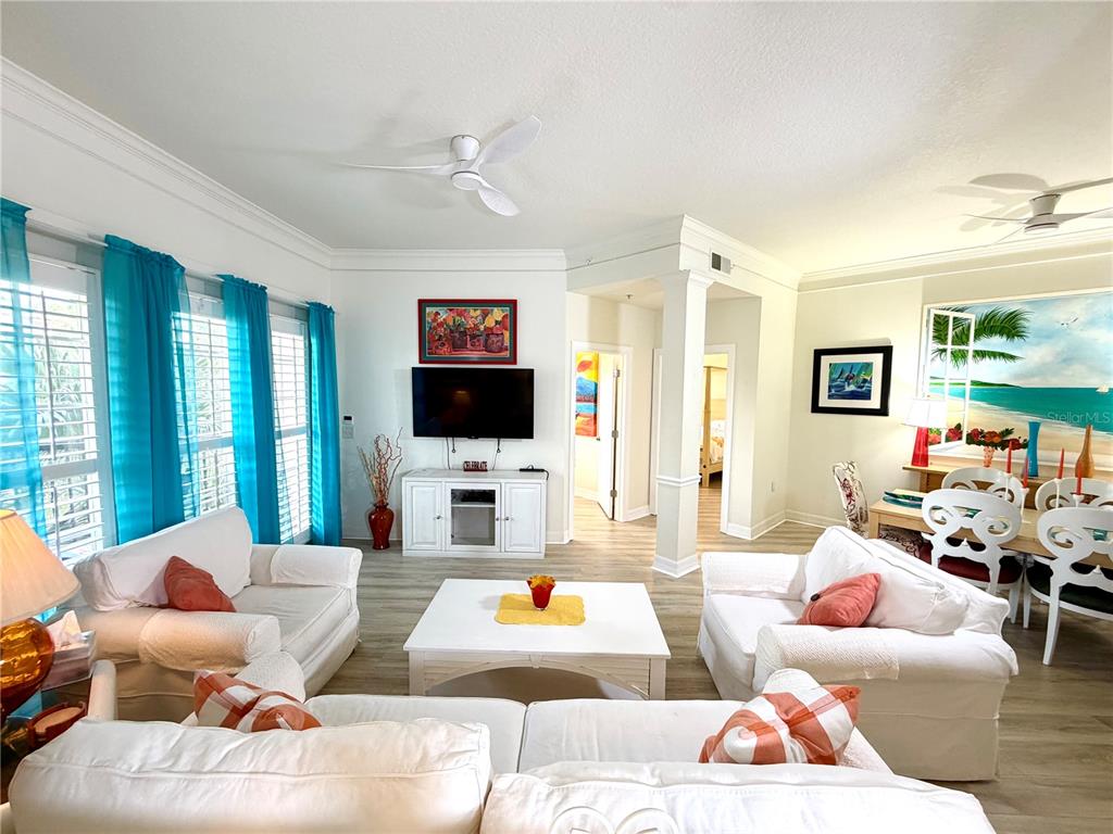 A living room features white slipcovered furniture, a coffee table, and built-in arched wall niches — 501 MIRASOL CIRCLE UNIT 308, CELEBRATION, FL