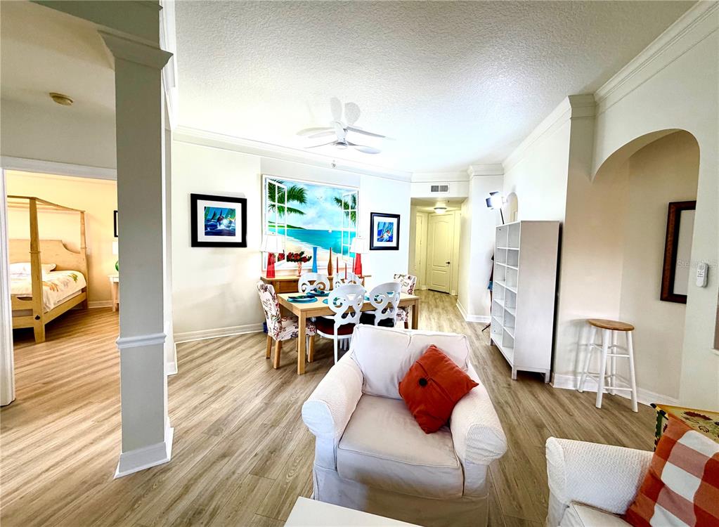A living room features white sofas, a central coffee table, and blue curtains — 501 MIRASOL CIRCLE UNIT 308, CELEBRATION, FL