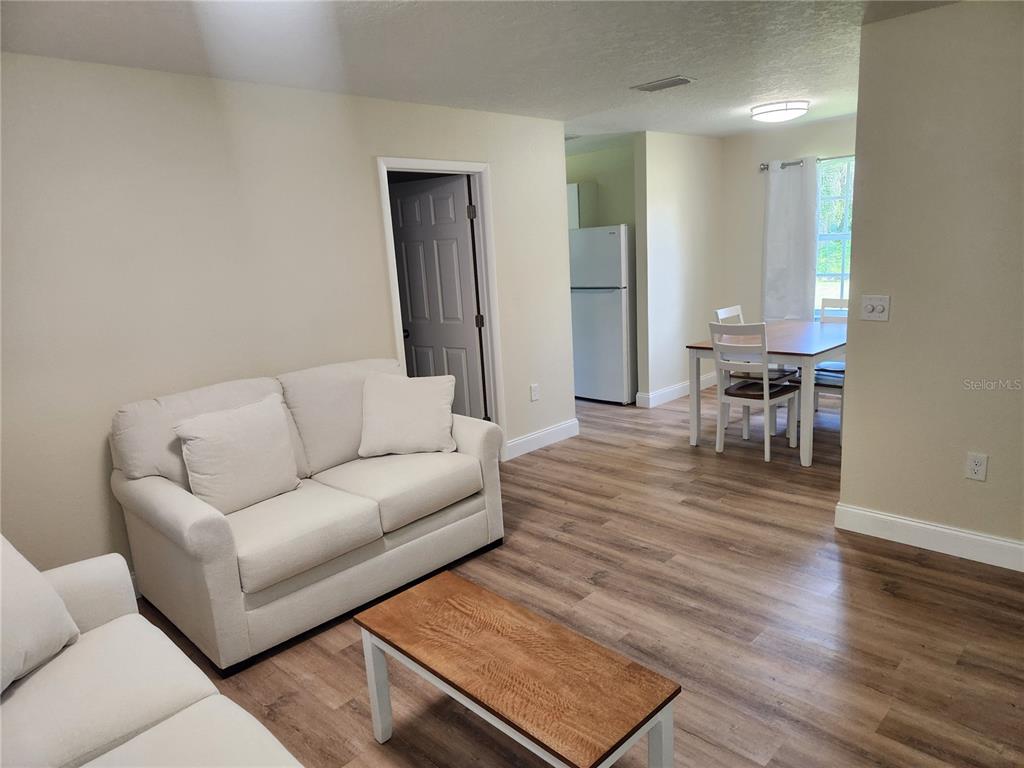 A bedroom with beige walls, gray carpet, a ceiling light, and a single window — 1652 SW HARLEM CIRCLE, ARCADIA, FL
