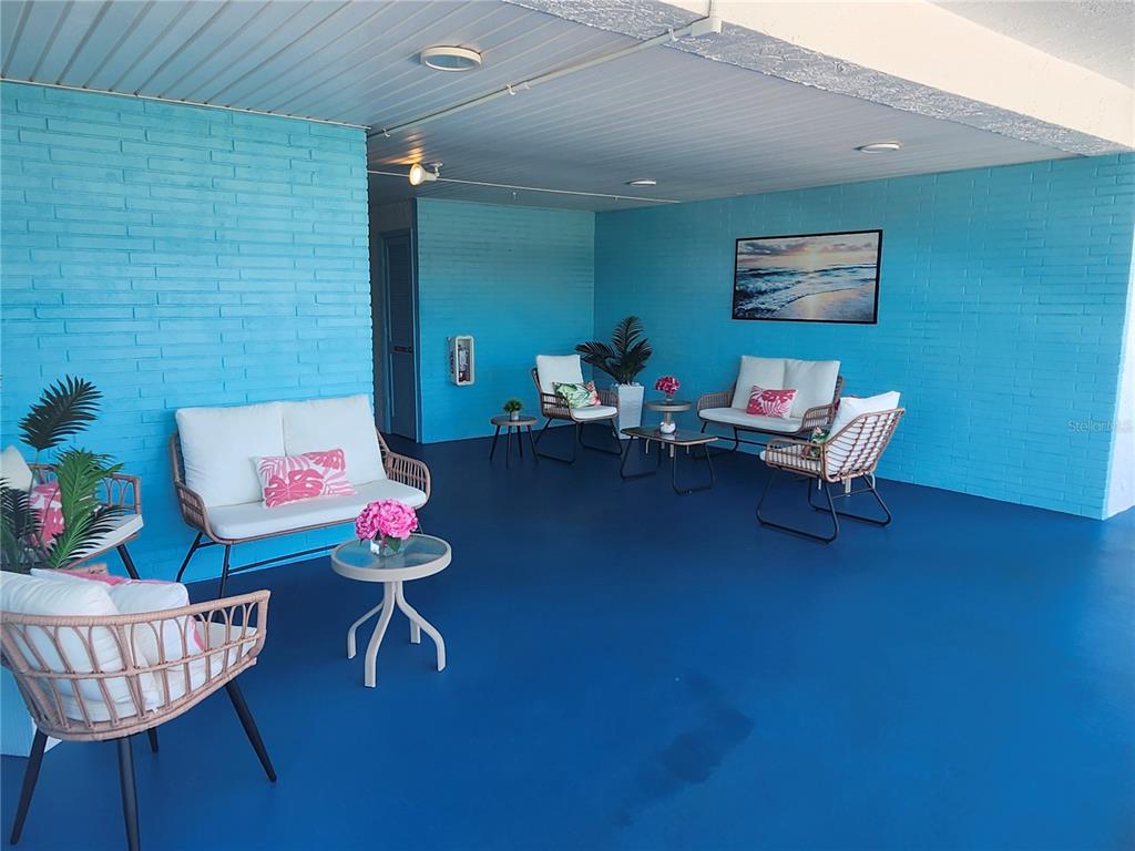 A pond with two fountains sits in front of multi-story apartment buildings and large trees — 5970 80TH STREET N UNIT 409, ST PETERSBURG, FL