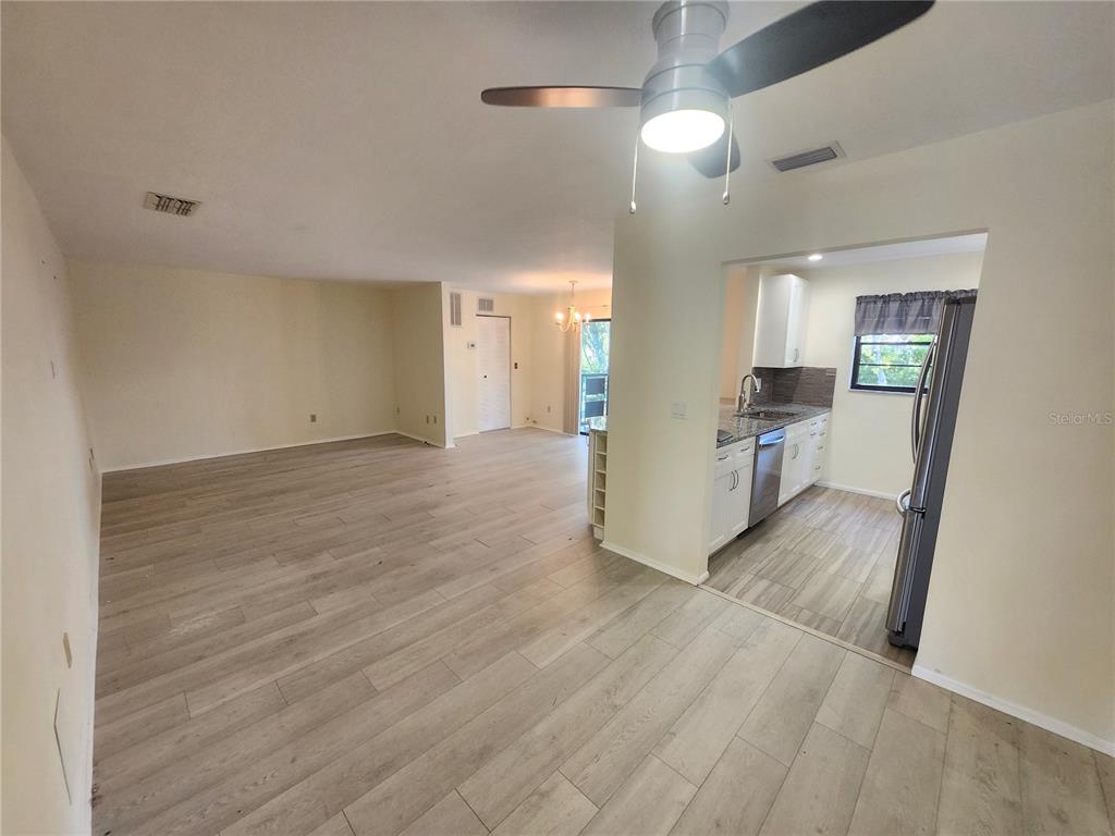 A white stucco wall with the number 409 leads to a dark brown front door — 5970 80TH STREET N UNIT 409, ST PETERSBURG, FL
