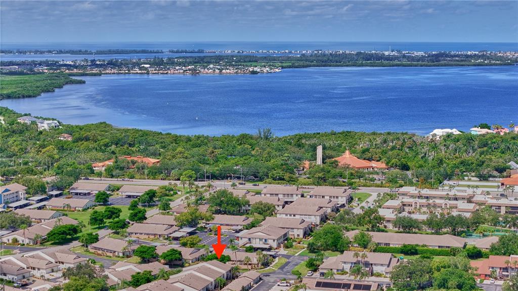 An aerial view of a residential complex with a red arrow pointing to a specific unit — 7163 28TH AVENUE W UNIT 7163, BRADENTON, FL