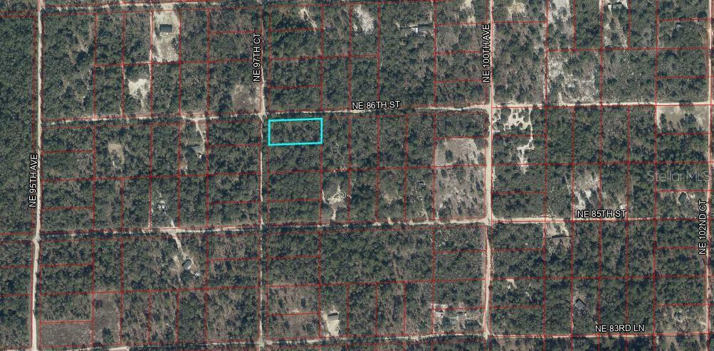 This is an aerial map showing a rectangular plot of land highlighted in blue — TBD NE 86TH STREET, BRONSON, FL