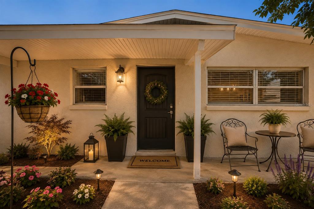 A single-story house with a concrete driveway, a covered carport, and a tan exterior — 541 FIREFLY LANE, APOLLO BEACH, FL