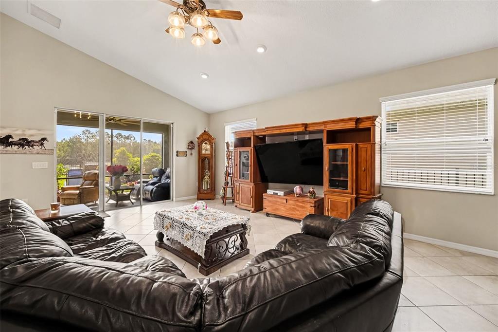 A kitchen features a granite island, stainless steel appliances, and light-colored cabinetry — 43 LAGOON WAY, PALM COAST, FL