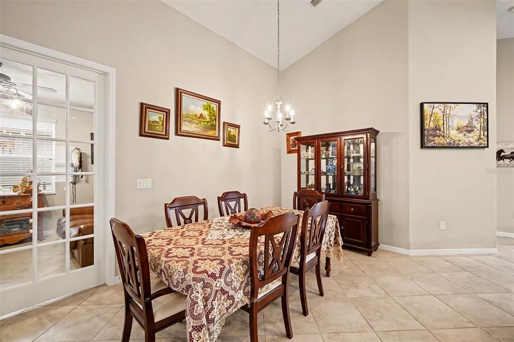 A bedroom with tile flooring, a wooden dresser, a ceiling fan, and a king-sized bed — 43 LAGOON WAY, PALM COAST, FL