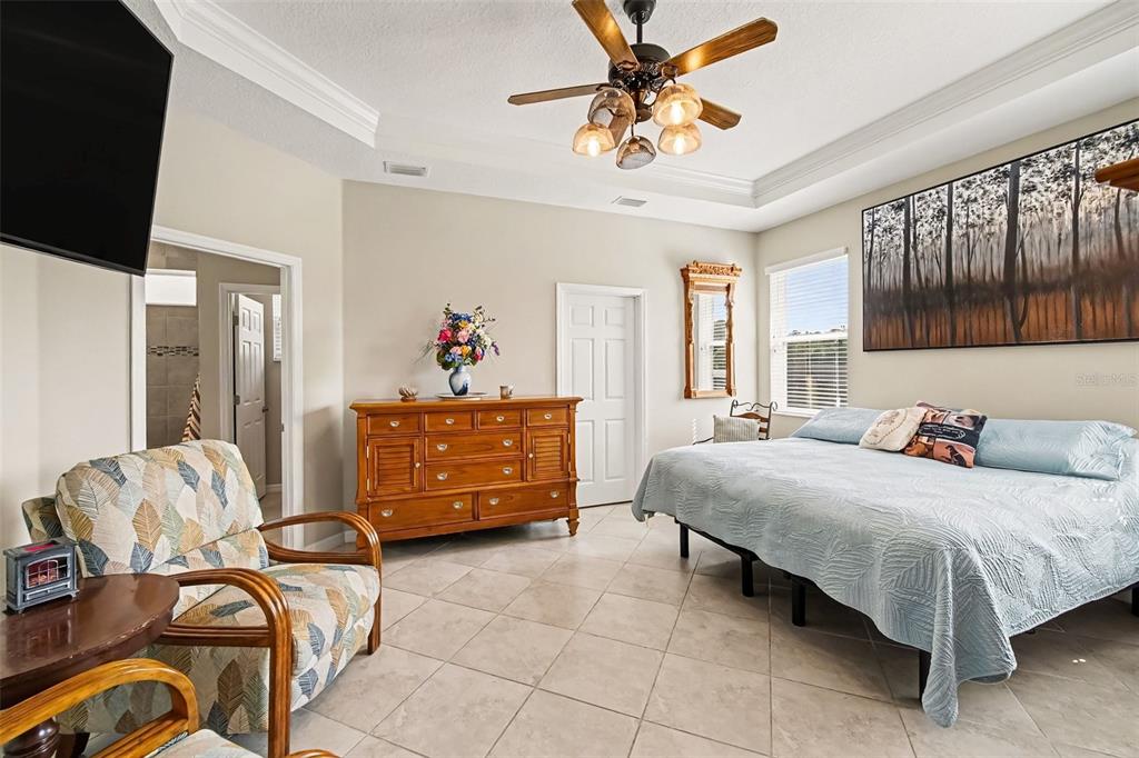 A kitchen features light gray cabinets, granite countertops, a center island, and stainless steel appliances — 43 LAGOON WAY, PALM COAST, FL